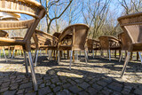 Fototapeta Kuchnia - empty wicker chairs of a cafe on the terrace, outside