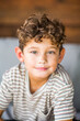 © digitalskillet1 - Handsome young boy with curly hair smiling.