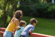 © digitalskillet1 - Portrait of a woman standing on a bridge with her children.