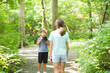 © digitalskillet1 - Young boy taking photo of his sister in the forest.