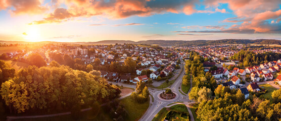 Wall Mural - aerial panorama of a european town at sunrise, with magnificent colorful sky and warm light
