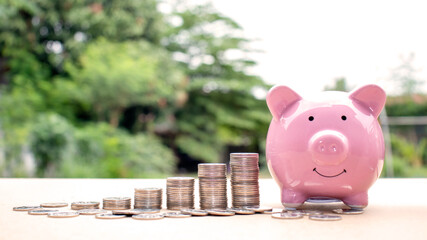 Wall Mural - The piggy bank includes a pile of coins, ideas for savings and financial growth.