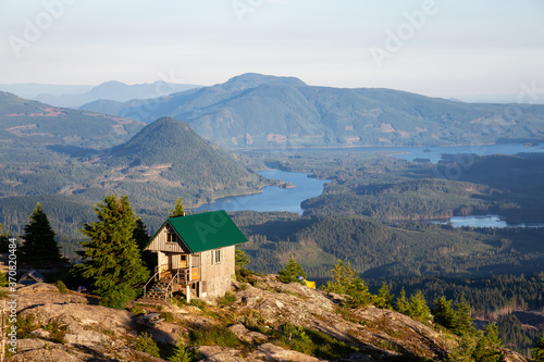 View of Tin Hat Cabin on top of a mountain during a sunny summer evening. Located near Powell River, Sunshine Coast, British Columbia, Canada.