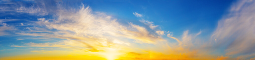 Wall Mural - panorama of the evening dramatic sky with bright sun