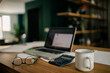 © Ekaitz Gerique/ADDICTIVE STOCK - Modern workspace of bookkeeper with netbook on documents and calculator placed on wooden table with eyeglasses and cup of coffee