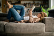 © Ekaitz Gerique/ADDICTIVE STOCK - Side view of pensive female in casual wear lying on sofa at home and enjoying interesting novel while relaxing during weekend