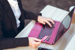 © Juan Alberto Ruiz/ADDICTIVE STOCK - Crop of above view of young Asian business lady in formal suit with credit card using laptop during online payment while sitting at table at workplace on terrace