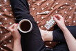 © Juan Alberto Ruiz/ADDICTIVE STOCK - From above unhealthy cropped unrecognizable female sitting on bed with cup of hot beverage and paper handkerchiefs while treating cold with medicine