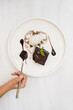 © Julio Feroz/ADDICTIVE STOCK - Top view of faceless person having bite of chocolate square cake with ganache and ice cream