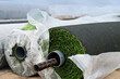 © Kavi Sanchez/ADDICTIVE STOCK - Rolls of green synthetic tuft wrapped in plastic material placed on ground on field