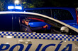 © Oscar Carrascosa/ADDICTIVE STOCK - Side view of male police officer sitting in parked automobile with siren light