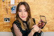 © Pedro Talens/ADDICTIVE STOCK - Charming female influencer in elegant wear standing with palette of eyeshadow and cosmetic brush while looking at camera making a tutorial