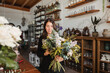 © Raquel Arocena/ADDICTIVE STOCK - Front view of concentrated female designer arranging decorative blooming bouquets while working on order for event in creative floristry studio