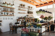 © Raquel Arocena/ADDICTIVE STOCK - Interior of modern floral shop with various bouquets and decorative pots and vases arranged on wooden counters and shelves inside spacious pavilion