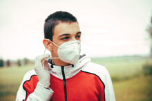 Portrait Of Teenager Wearing Protective Mask Outdoors