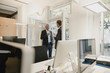 © Westend61 - two businessmen standing in office, drinking coffee, talking