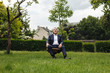 © Westend61 - Senior businessman sitting on a chair in a rural garden looking up