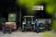 © Westend61 - Confident senior man on a farm with tractor in barn