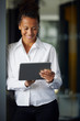 © Westend61 - Portrait of smiling businesswoman using digital tablet in office