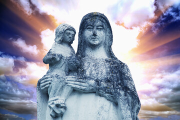 Sticker - Queen of Heaven. Ancient statue of the Virgin Mary with Jesus Christ (against dramatic view of of cloudy sky