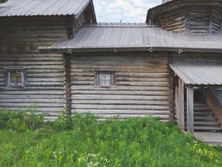 Wall Mural - Facade of old wooden house. small windows. entrance with porch. traditional architecture