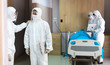 © NVB Stocker - Doctor and medical technicians in protective disease PPE suit uniform and face mask working during covid-19 period at hospital