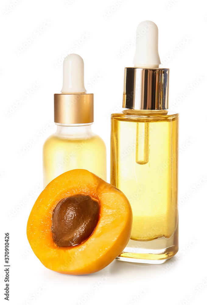 Bottles of apricot essential oil on white background