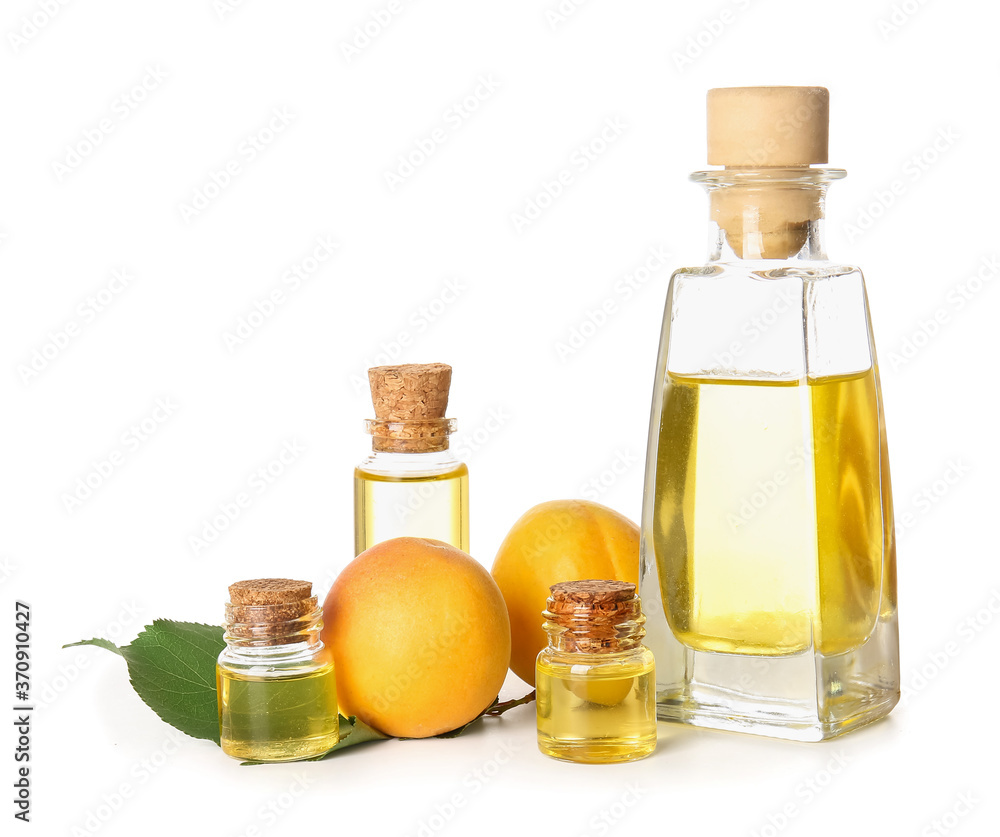 Bottles of apricot essential oil on white background