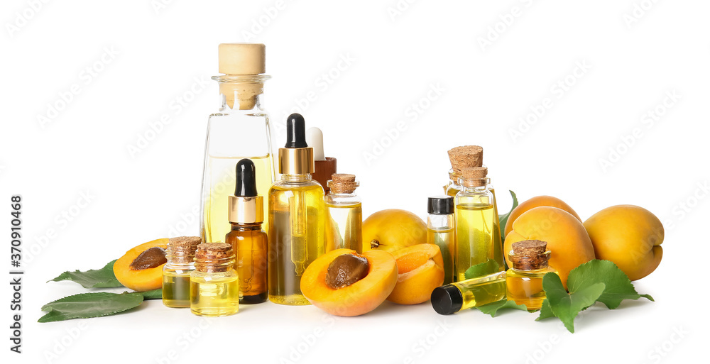 Bottles of apricot essential oil on white background
