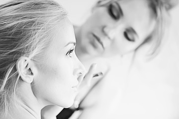 vintage black and white photo of a girl with professional make-up / strict make-up on the face of a beautiful professional model in a beauty salon