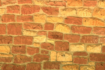 Old brick wall, old texture of red stone blocks closeup