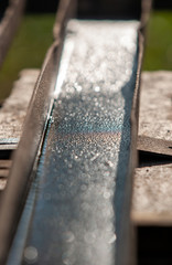 wet rusty channel on a wooden workbench