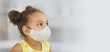© ShunTerra - A dark-skinned girl in a medical mask for respiratory protection, yellow dress