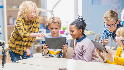 School Computer Science Class: Schoolchildren Use Digital Tablet Computers and Smartphones with Augmented Reality Software, They’re Excited, Full of Wonder. Children in STEM, Playing and Learning