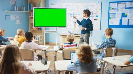 Wall Mural - elementary school physics teacher uses interactive digital whiteboard with green screen mock-up temp