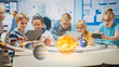 © Gorodenkoff - Group of School Children in Science Class Use Digital Tablet Computers with Augmented Reality Software, Looking at Educational 3D Animation Of Solar System. VFX, Special Effects Render