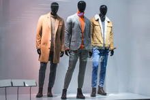 Three Male Mannequins In Store Window Show Autumn Winter Collection For Men. Dummies On Isolated Background