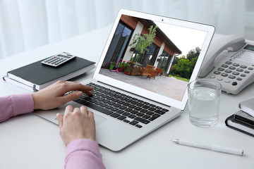 Businesswoman or real estate agent looking through online property portfolio, closeup