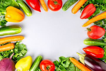 Assortment of fresh vegetables on grey background, top view with copy space. Healthy raw food.