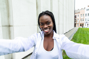 Portrait of an attractive young african american woman taking a selfie with her mobile phone