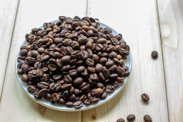 Poster - White mug with Cup of coffee beans on wooden background with selective focus and crop fragment