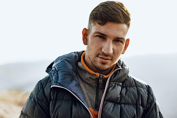 Wall Mural - Portrait of a young caucasian man hiking in the mountains