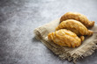 Curry puff pastry on concrete background.