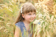 Portrait Of A Blue-eyed Little Girl In Spikelets