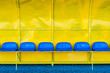 Yellow football reserve and staff coach bench with blue sits