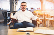 © BullRun - Successful popular male writer dressed in stylish clothes spending his free time on work reading literature and preparing new book for release cooperating with skilled editors and journalists
