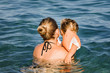 © amelie - Mother playing with daughter in sea