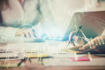 Multi exposure of woman hands typing on computer and forex chart hologram drawing. Stock market analysis concept.