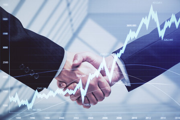 Double exposure of forex graph hologram and handshake of two men. Stock market concept.