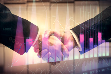 Double exposure of forex graph hologram and handshake of two men. Stock market concept.